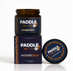 Paddle Pro Recovery Balm jar stacked on top of branded product box with lid displayed to the side.